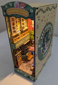 an open cardboard box with a doll house inside