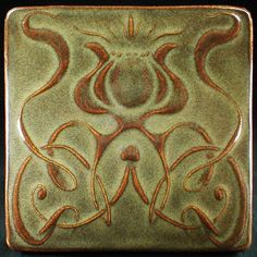 a square tile with an intricate design on it