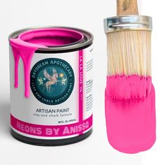 a pink paint can with a brush next to it that is being used for painting