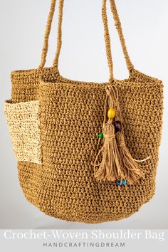 a crochet woven shoulder bag with tassels and beads hanging from it