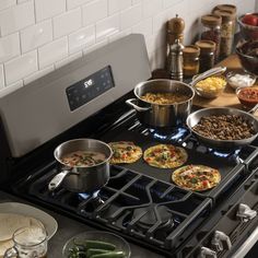 an oven with many pots and pans on the burners in front of it