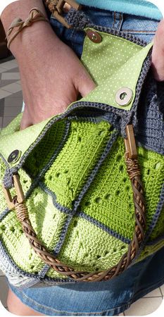 a woman is holding a green and blue purse