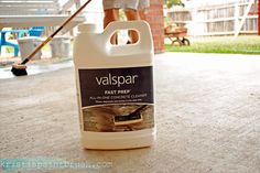 a gallon of varispari next to a person with a mop on the ground