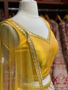 Daisy white brocade print skirt with golden border paired with contrasting yellow plain blouse and net dupatta. Fabric: Georgette This outfit can be customized in multiple colors and specific to client measurements. 90 days of production time is required and are for bulk orders only! Orders are processed in store only! Final fittings/alterations not included. Minimum Order Quantity- 4 pieces Gold Organza Choli With Unstitched Blouse, Traditional Organza Sets With Gold Embroidery, Yellow Organza Sets For Navratri, Yellow Elegant Lehenga With Sheer Dupatta, Yellow Bollywood Organza Sets, Elegant Yellow Lehenga With Sheer Dupatta, Yellow Organza Lehenga With Traditional Drape, Yellow Organza Lehenga With Pallu, Yellow Organza Lehenga With Pallu Detail