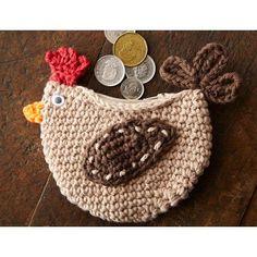 a crocheted coin purse with a chicken on it and some coins in the background