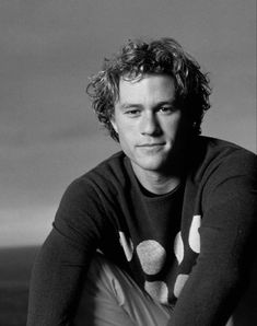 a black and white photo of a man with curly hair