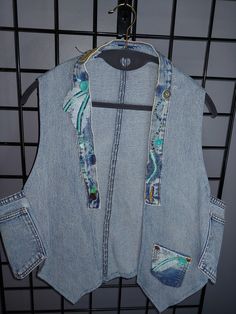 "This handmade vest is made out of recylced blue jeans.  Super fun!  If you like individuality, you'll love it.  I put medium as a size but these vests fits most.  The look is a bit different on my 5'1\" small busted frame than a 5'8\" gal with a larger bust.  I personally think they look even better on larger gals.  Just saying'!  But I love mine as well." Blue Patchwork Vest For Spring, Bohemian Vest With Pockets For Spring, Bohemian Spring Vest With Pockets, Spring Bohemian Vest With Pockets, Sleeveless Denim Vest For Festivals, Spring Medium Wash Recycled Denim Vest, Light Wash Denim Vest With Pockets, Bohemian Denim Vest For Spring, Bohemian Blue Sleeveless Denim Vest