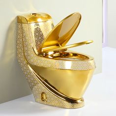 a gold colored toilet with its lid open