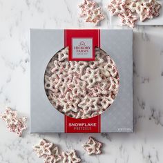 a box of snowflake treats sitting on top of a marble counter