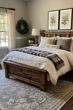 a bedroom with a bed, rug and two framed pictures on the wall above it