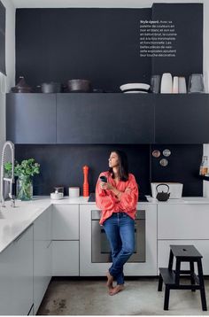 a woman standing in a kitchen next to a counter