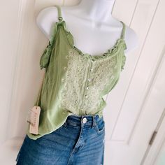 Shyanne Green Sage & Gold Sequin Strappy Lettuce Edge Embroidered Blouse Sz Xs. This Adorable Strappy Tank Top Is Just The Right Amount Of Summer And Shimmer! Features Adjustable Straps And Spare Sequins. The Embroidery Detail On This Blouse Is Beautiful! Pairs Well With Jeans And Boots/Sandals. Measures 19 1/2” Pit To Pit 23” In Length (Adjustable Straps!) Comes From A Smoke-Free, Doggo Loving Home :) Spring Cotton Lace Top With V-neck, Cotton Lace V-neck Top For Summer, Trendy Lace Trim Camisole For Summer, Trendy Summer Camisole With Lace Trim, Crochet Cami Top For Day Out, Summer Green Crochet Top, Cotton Lace Top For Summer, Summer Cotton Lace Top For Vacation, Trendy Lace Trim Camisole For Spring