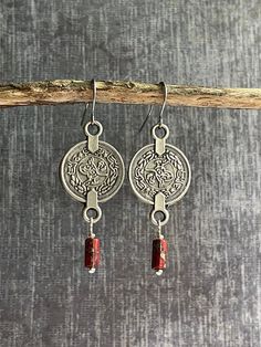 These long silver coin dangle earrings feature beautifully detailed silver plated coin charms and stunning red Picasso glass beads that hang from nickel free iron ear wires. The charms have the same design on the front and back which make them perfect for those with short hair! They are very light weight and so versatile they'll go with everything in your closet!   Earrings measure 5 cm drop length by 1.7 cm wide. Silver Red Coin Earrings / Turkish Earrings / Ethnic Earrings / Tribal Earrings / Bohemian Sterling Silver Coin Jewelry, Nickel Free Coin Shaped Sterling Silver Earrings, Nickel Free Medallion Earrings Gift, Nickel Free Sterling Silver Coin Earrings, Nickel Free Coin-shaped Sterling Silver Earrings, Nickel-free Medallion Earrings For Gift, Nickel-free Sterling Silver Coin Earrings, Nickel-free Coin-shaped Sterling Silver Earrings, Handmade Medallion Sterling Silver Earrings