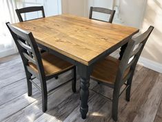 a wooden table with four chairs around it