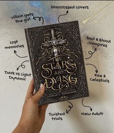 a hand holding up a book with the words stars and rings on it