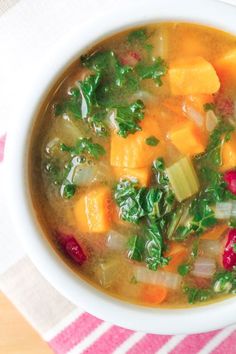 a white bowl filled with soup on top of a table