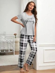 Discover ultimate comfort with our Graphic Tee And Plaid Print Pants Pajama Set. Embrace style effortlessly with plaid and slogan patterns. Designed for relaxation, this pant set offers a loose-fit pajama and short-sleeved tee. Crafted from a fabric with a slight stretch, it ensures unrestricted movement. Enrich your loungewear collection with this blend of style and ease. Features: Pattern Type: Plaid, Slogan Type: Pant Sets Neckline: Round Neck Sleeve Length: Short Sleeve Fit Type: Loose Shee Plaid Cotton Loungewear Sets, Cotton Plaid Sleepwear For Loungewear, Comfortable Plaid Cotton Sleepwear, Plaid Cotton Sleepwear For Loungewear, Plaid Relaxed Fit Sleepwear For Loungewear, Casual Plaid Cotton Sleepwear, Cotton Plaid Sleepwear For Lounging, Plaid Cotton Sleepwear For Lounging, Plaid Casual Sleepwear For Lounging