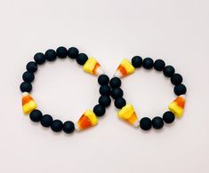 Lightweight 8mm black bead bracelet with candy corn glass beads on stretch cord. These trendy, fun bracelets are customized just for you! Each one is perfect on its own or layered with even more bracelets! (Message me for layering and stack ideas!) These are perfect gifts for birthdays or holidays, gifts, or as birthday/halloween party favors! This listing is for 1-4 bracelets. Please indicate if you would like a "big" one, "Little one" or 1 or more of each. Message me for bulk order details! Bracelet will be made with 3 candy corn beads. If you would like this bracelet personalized with a name or word please add that before checking out.  Average Kids Size: Newborn-6 months: 4"-4 ½" 6-12 months: 4 ½"- 5" 1-4 years: 5" - 5 ½" 4-7 years: 5 ½" - 6" 7-10 years: 6" - 6¼" Teen: 6 ½" - 7" + Stan Halloween Novelty Black Bracelets, Novelty Black Beaded Bracelets For Halloween, Halloween Black Bracelets With Round Beads, Black Round Bead Bracelets For Halloween, Black Beaded Bracelets For Halloween, Black Round Beaded Bracelets For Halloween, Black Novelty Bracelets With Round Beads, Black Novelty Stretch Bracelet As A Gift, Black Novelty Stretch Bracelet For Gift