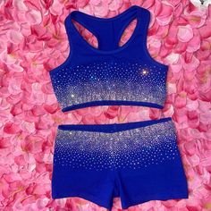 a women's blue sports bra top and shorts with sparkling stars on the bottom