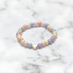 Introducing Our Pastel and Heart Bead Bracelet Our "Sweetheart" Pastel and Heart Bead Bracelet offer a unique combination of vibrant pastel shades and adorable heart details. These beautiful accessories are crafted with care, utilizing and are perfect for showing someone (or yourself) some love. PURCHASE OPTIONS Can be purchased individually - individual bracelets are listed by heart bead metal OR You can purchase them as a stack set. If you do, you will receive a 10% price discount on all the b Rose Gold Bracelets With Round Beads For Valentine's Day, Everyday Rose Gold Bracelet With Heart Charm, Rose Gold Heart Beaded Bracelet, Rose Gold Heart Charm Bracelet For Friendship, Dainty Rose Gold Bracelets With Heart Beads, Adjustable Rose Gold Charm Bracelet With Heart Charm, Everyday Rose Gold Heart Bracelets, Rose Gold Beaded Bracelets With Heart Charm As Gift, Hypoallergenic Heart-shaped Beaded Bracelets For Everyday