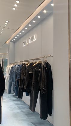 clothing rack with denim clothes in miu miu store Miu Miu Store Aesthetic, Clothing Store Aesthetic Interior, Luxury Store Aesthetic, Boutique Aesthetic Ideas, Dior Store Aesthetic, Fashion Store Design Boutiques, Harrods Aesthetic, Flagship Store Design, Luxury Boutique Interior