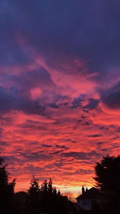 the sky is pink and purple as the sun sets