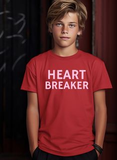 Make Valentine's Day extra special for your little heartbreakers with our 'Heart Breaker' kids tee! This playful shirt, adorned with vibrant pink font on a striking red background, is the perfect way for your kids to celebrate the love-filled occasion. Crafted with comfort in mind, it adds a festive touch to their wardrobe while capturing the fun spirit of Valentine's Day. Ideal for classroom parties, family gatherings, or just spreading love around, this tee lets your little ones showcase their unique personality in style. Embrace the Valentine's Day spirit with our heartwarming 'Heart Breaker' tee for kids. Order now and let the love festivities begin!  #ValentinesDayKids #HeartBreakerTee #LoveFilledFashion ♥ Gildan 5000b T-Shirt ♥ Made with 100% COTTON ♥ Wash and dry normally (on cool f Playful Pink T-shirt With Slogan, Pink Heart-shaped Graphic Print T-shirt, Pink Heart Print T-shirt For Valentine's Day, Pink Valentine's Day Graphic Tee, Playful Pink T-shirt For Valentine's Day, Playful Graphic Print T-shirt For Valentine's Day, Playful Crew Neck T-shirt For Valentine's Day, Playful Valentine's Day Crew Neck T-shirt, Valentines Day Kids