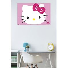 a hello kitty wall hanging above a desk