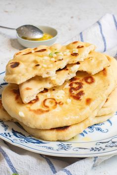 three flat breads stacked on top of each other on a blue and white plate