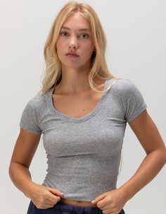 Tilly's V-Neck Rib Tee. V-Neckline. Rib Knit Construction. Short Sleeves. Breathable And Lightweight Fabric. 60% Cotton, 35% Polyester, 5% Spandex. Machine Wash. Imported. Model Is Wearing A Size 26. Model Measurements:height: 5'8" Bust: 32"waist: 25"hips: 35" | Tillys V-Neck Rib Tee Basic Fitted V-neck Top, Fitted V-neck Top For Everyday, Everyday Seamless V-neck Tops, Casual Stretch V-neck Crop Top, Trendy Seamless Relaxed Fit Tops, Casual V-neck Stretch Crop Top, Stretch Scoop Neck Top For Loungewear, Basic V-neck Stretch Crop Top, Fitted V-neck Basic Tops