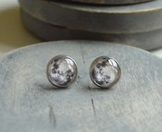 "Stud earrings made with Mercury cabochons set in surgical steel post settings. Nickel free and gold plated are also available.  The earring measures 14mm (.55\") across.  Examples are shown in the photos: Stud earrings - 12mm, 14mm or 16mm in surgical steel, nickel free or gold plated  14mm and 16mm Stainless Steel Cuff Links Dangle Earrings- Sterling, gold filled, surgical steel or nickel free French ear wires - 1 inch long, 14mm diameter Lever Back Earrings- Surgical Steel or Gold Plated - 1 Brass Keychain, Planet Jewelry, Anime Earrings, Queen Jewelry, Keychain Clip, Minimalist Earrings Studs, Minimalist Studs, Silver Bow, Steel Post