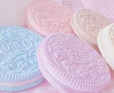 four cookies sitting on top of a pink and blue table cloth next to each other