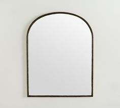 an arched mirror hanging on the wall