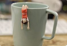 a person upside down in a coffee cup