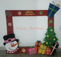 a frame with a snowman and christmas tree on it