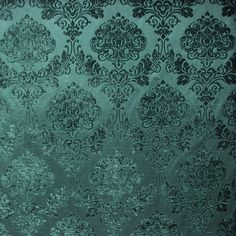 a green and black wallpaper with an intricate design on it's surface,