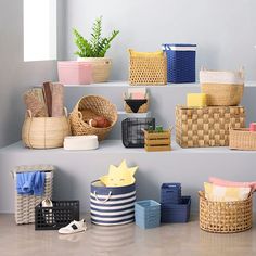 several baskets are lined up on the shelves next to each other in different colors and sizes