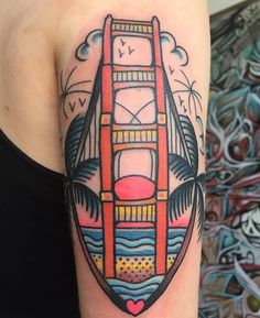 a colorful tattoo with a tower bridge and palm trees on the side of his arm