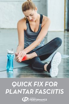 a woman sitting on the ground with her hand in her pocket and holding a water bottle