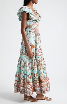 Hand-placed crystals highlight the neckline of this ruffle-wrapped linen maxi featuring an array of gorgeous flora and intricate eyelet accents. Australian designer Camilla Franks often takes inspiration from far-flung destinations—case in point: this ornate print pays tribute to the history and natural beauty of Egypt. 55 1/2" length (size Medium) Ties at back V-neck Cap sleeves Smocked waist Partially lined 100% linen Dry clean Imported Designer Clothing Linen Maxi Dress, Australian Design, Nordstrom Dresses, The History, Cap Sleeves, Smocking, Natural Beauty, Designer Clothing, Dry Clean