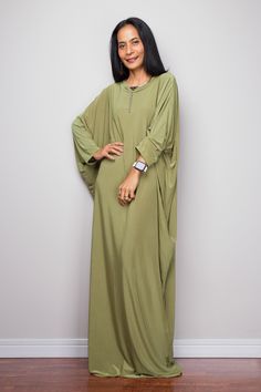 "Olive Green Kaftan Dress, Maxi Dress, Long boho dress, Loose fit dress, Modest dress, Green kaftan with pockets PRODUCT SIZE : One Size Fits Most * Chest : free up to 58\" * Waist : free up to 58\" * Hips : free up to 58\" * Circumference bottom hem : 45\" * Length : 56\" * Sleeve length : 23\" MATERIAL * Spandex Venetia * Zipper on the back MODEL : * Model chest : 32\", Height 160 cm (5.2) without high heel * Accessories excluded Produced by NUICHAN IMPORTANT NOTE *Please note that colours sho Green Fitted Long Kaftan, Green Flowy Long Kaftan, Oversized Green Long Kaftan, Green Oversized Long Sleeve Kaftan, Green Silk Floor-length Kaftan, Boho Dresses Long, Loose Fitting Dresses, Oversized Dress, Kaftan Dress