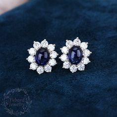 "❤Jewelry Details -Gold Type: Solid 14K Gold / Solid 18K Gold (Choose One in Material Option) Center Stone: Lab Created Blue Sapphire 7*9mm, Approximately 2.65ct*2pcs Color: 5A Clarity: VVS Cut: Oval Cabochon Cut / 3EX Side Stone: Moissanite, 3.5mm*20pcs Side Stones Total Carat Weight: 3.0ctw Color: EF Clarity: VVS1 Cut: Round Cut / 3EX SKU: YE0052 ~*-*~Purchase Guarantee: - All our jewelry is handmade, and each process is refined. - 14 Day Refund Guarantee. - All our products are Free Shipping. Oval Sapphire Earrings Fine Jewelry, Fine Jewelry Sapphire Oval Earrings, Blue Oval Cabochon Earrings For Gift, Blue Oval Cabochon Earrings As Gift, Oval Sapphire Earrings Hallmarked, Oval Cabochon Earrings For Anniversary, Blue Oval Hallmarked Earrings, Oval Sapphire Earrings With Halo Setting, Elegant Blue Oval Cabochon Earrings