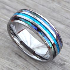 a wedding ring with blue and white opalite inlays on the inside