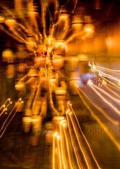 blurry photograph of street lights at night with long exposure and light streaks on the road