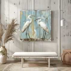 two white birds are standing in front of a blue background on a wooden paneled wall