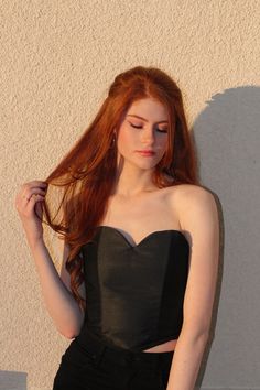 A red headed model is wearing a black satin heart shaped corset top. This corset is exclusively made & sold by I. M. WALKER. Heart Shaped Corset, Heart Corset, Crop Top Satin, Sweetheart Corset, Black Satin Fabric, Fashion Corset, Satin Bustier, Corset Black, Satin Crop Top