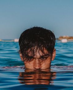 a man swimming in the ocean with his head above water