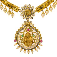 Radiate upon arrival with this exquisite 22K Yellow Gold Hasdi Paachi Necklace & Chandbali Earring set from Virani Jewelers! Features: • Detailed collar necklace • Encrusted with precious rubies, emeralds, CZ gems and pearls • Large Laxmi eyelet pendant • Chandbali earrings Virani Jewelers is always committed to providing only the best in 22K gold jewelry and precious gemstones. This brilliant 22K yellow gold Hasdi Paachi necklace and Chandbali earrings set features an elegantly engraved collar Festive Temple Necklace With 17 Jewels In Chandbali Shape, Traditional Temple Necklace With 17 Jewels For Puja, Bollywood Temple Necklace With 17 Jewels For Festivals, 22k Gold Jewelry, Chandbali Earrings, Precious Gemstones, 22k Gold, Collar Necklace, Earrings Set