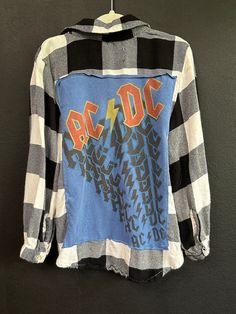 AC DC Flannel shirt. Perfectly imperfect! KIDS 5 for more specific sizing information reach out and I will measure! Distressed Cotton Collared Tops, Distressed Collared Cotton Top, Blue Grunge Top For Fall, Plaid Graphic Print Long Sleeve Shirt, Casual Flannel Shirt With Graphic Print, Long Sleeve Flannel Top With Graphic Print, Plaid Flannel Grunge Top, Plaid Cotton Tops With Letter Print, Grunge Plaid Flannel Tops