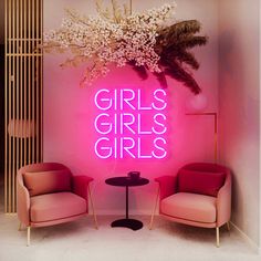 two pink chairs in front of a neon sign that says girls, girls, girls